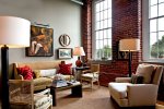 Classic-red-brick-wall-creates-a-lovely-ambinace-in-the-eclectic-living-room.jpg